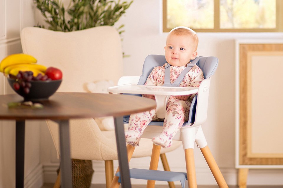 A baby in a Red Kite Feed Me Kombo highchair.